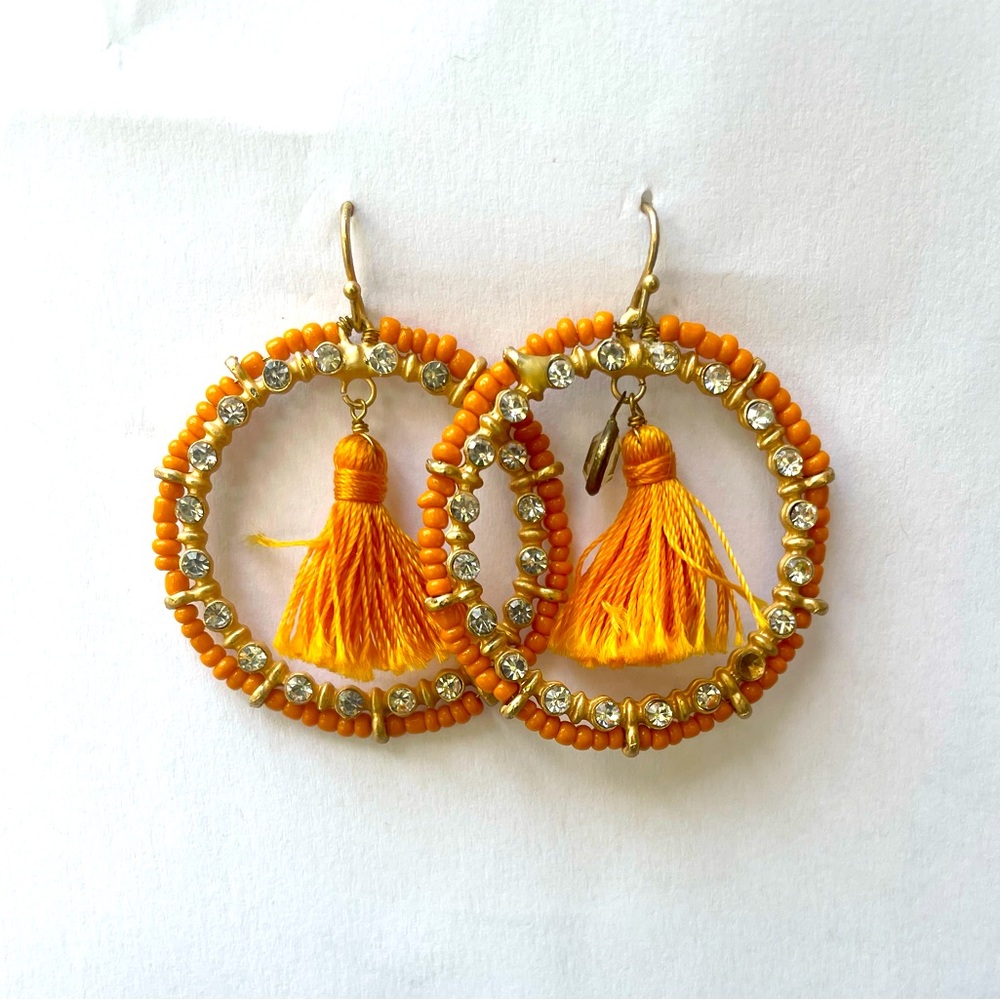 Orange beaded hoop earrings with fringe detail